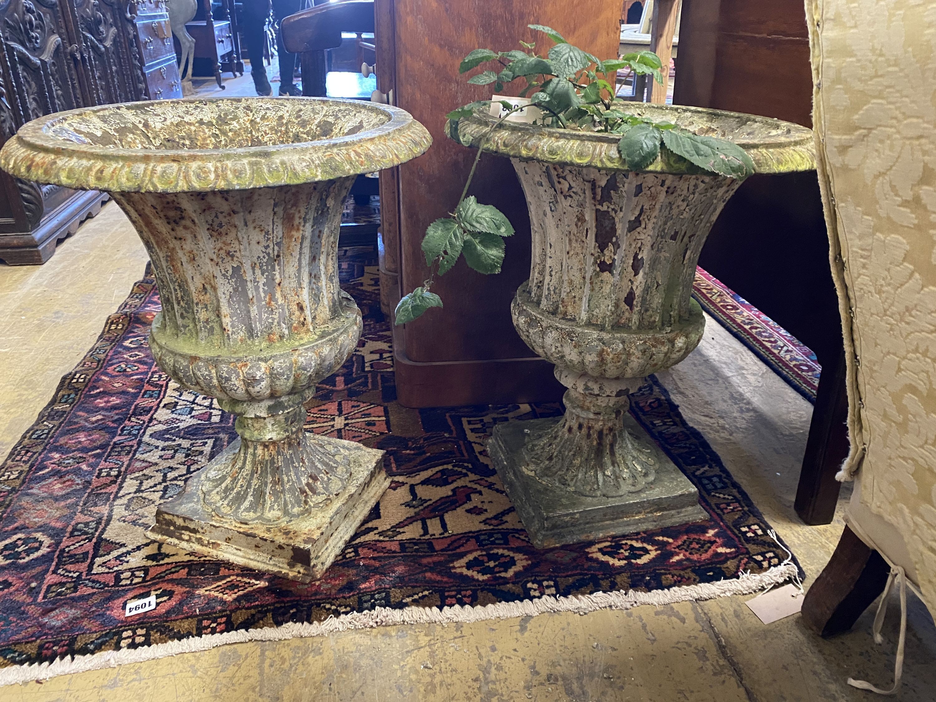 A pair of Victorian painted cast iron campana garden urns, a.f., diameter 44cm, height 50cm